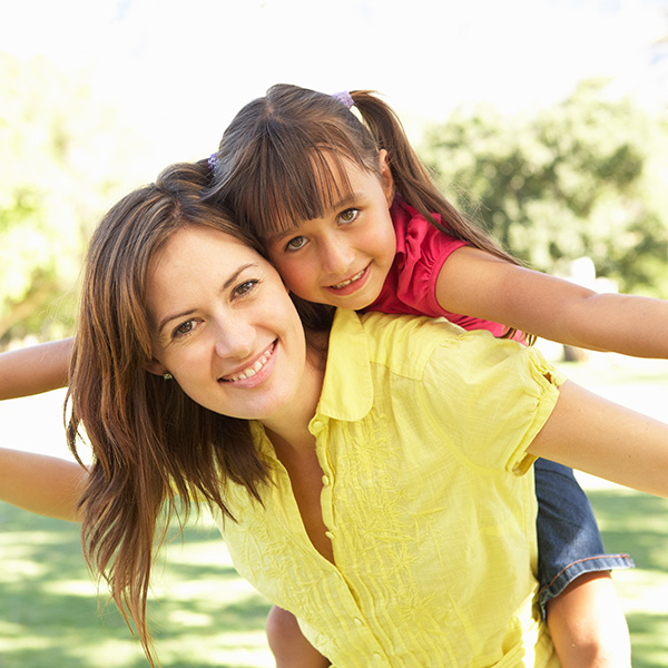 Happy mom and daughter playing at park
