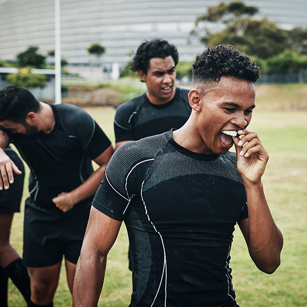 Rugby player removing his mouthguard