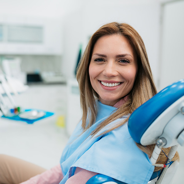 Happy woman visiting a dentist office