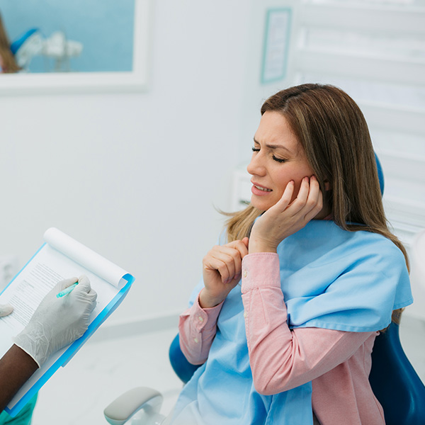 Female patient in distress, sitting in a dentist's office
