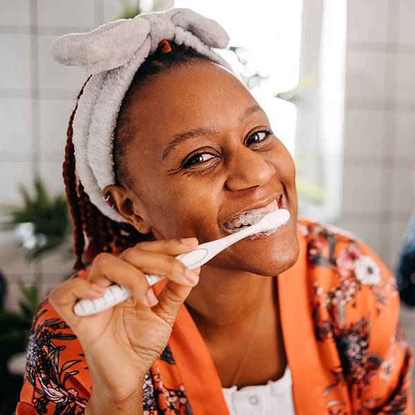 Woman brushing teeth in the morning