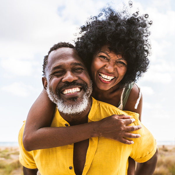 Happy couple smiling outside