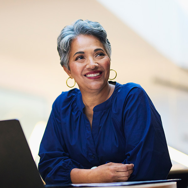 Happy woman smiling in front of computer